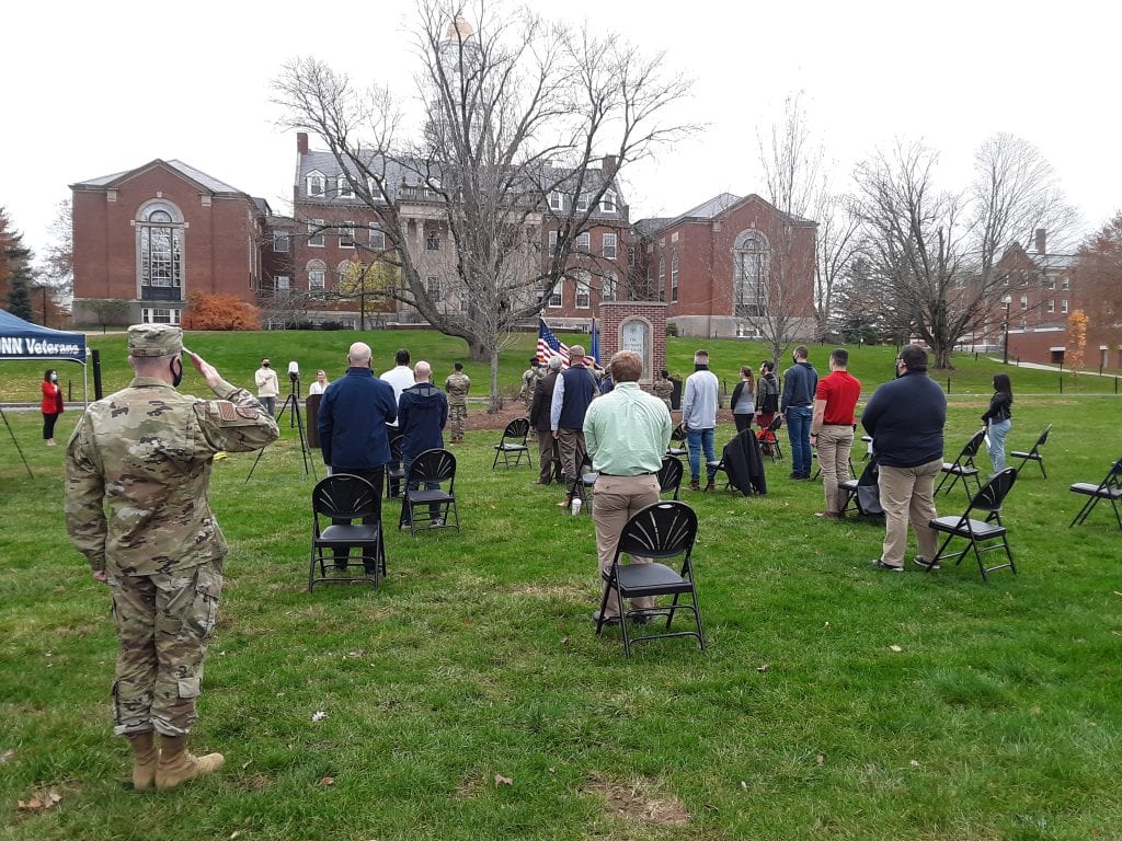 A small crowd who are distanced from each other on the Founder's Green for the Veterans Day Ceremony 2020.